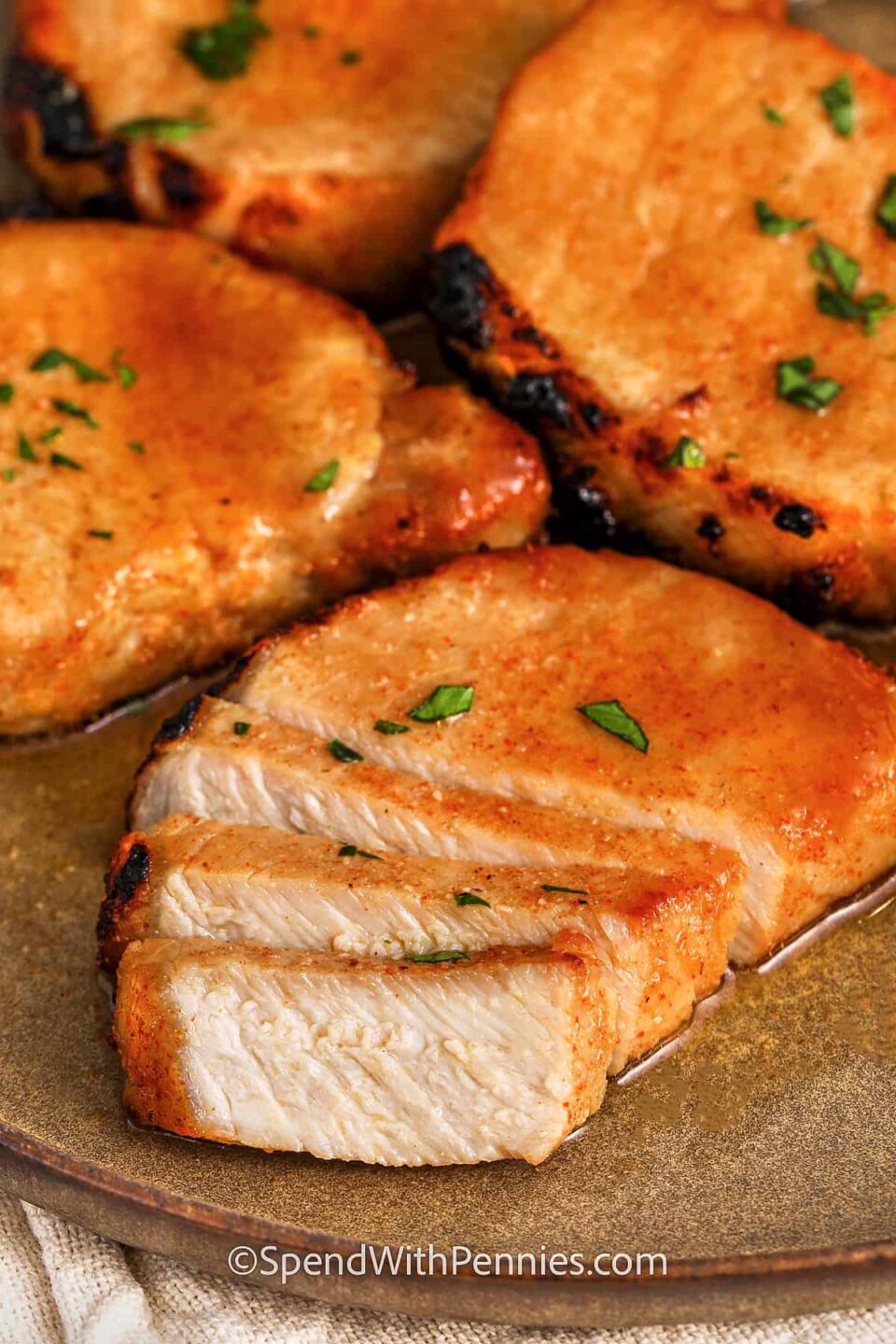 plated Juicy Baked Pork Chops with one cut into slices