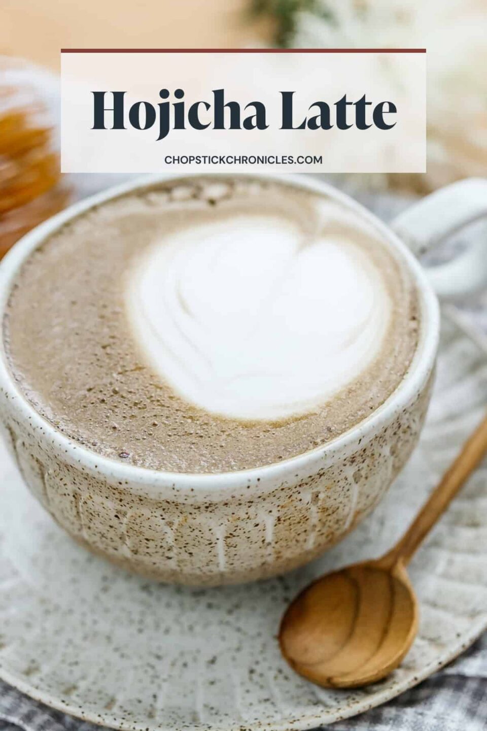 hojicha latte brewed in a cup and saucer with text overlay for pinterest