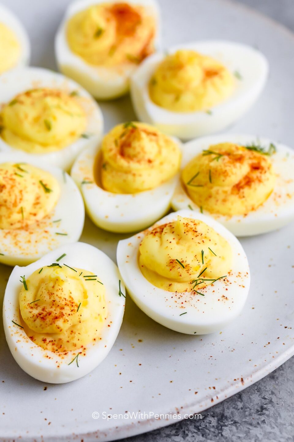 a plate of classic deviled eggs with paprika
