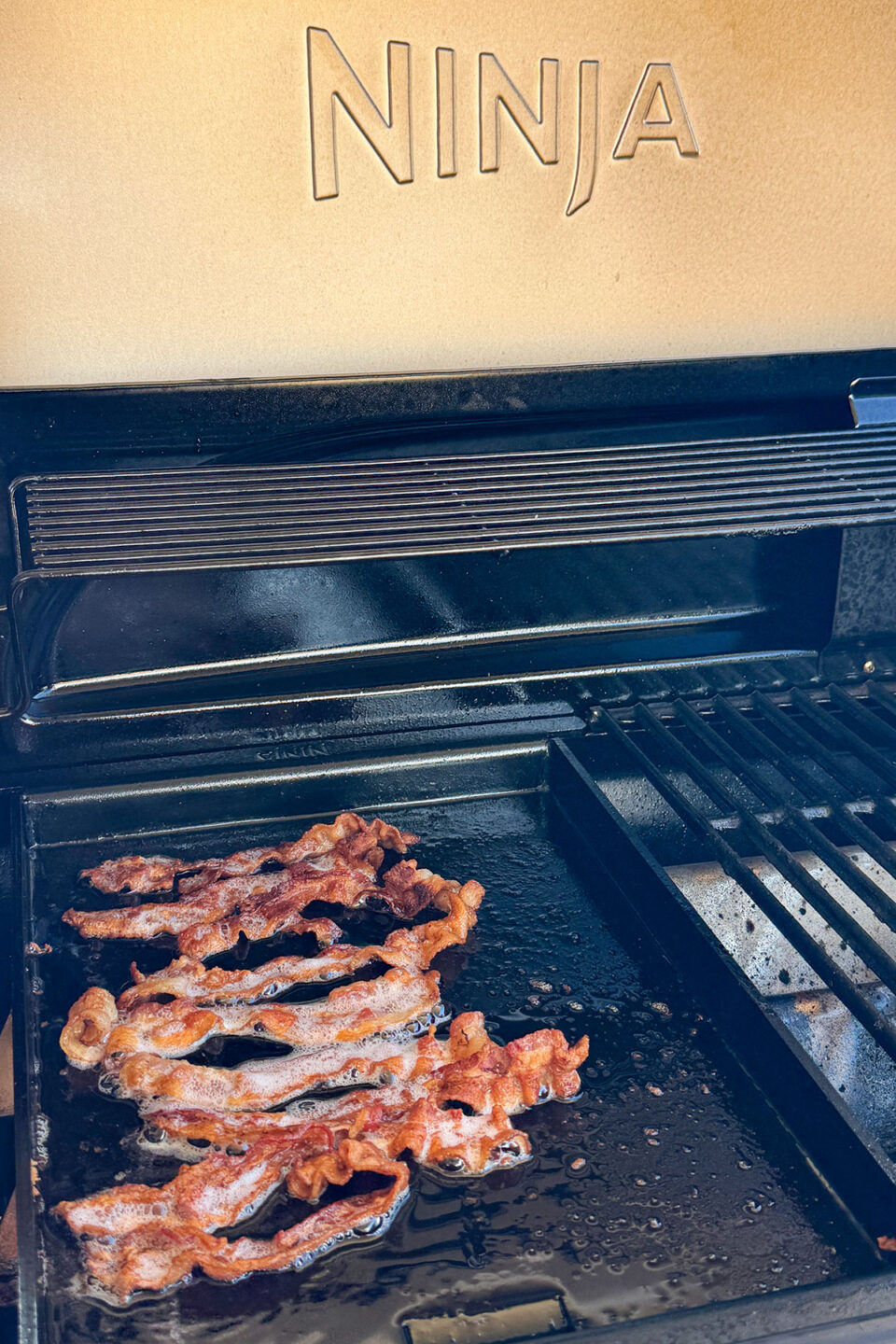 Ninja FlexFlame half griddle with bacon.